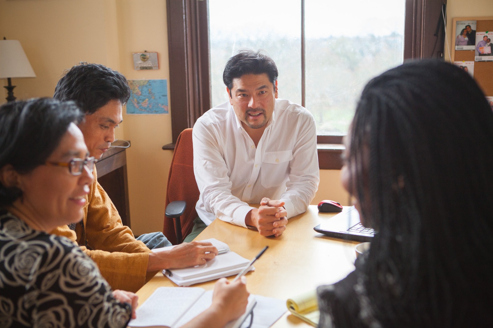 Britt Yamamoto consulting with Program participants